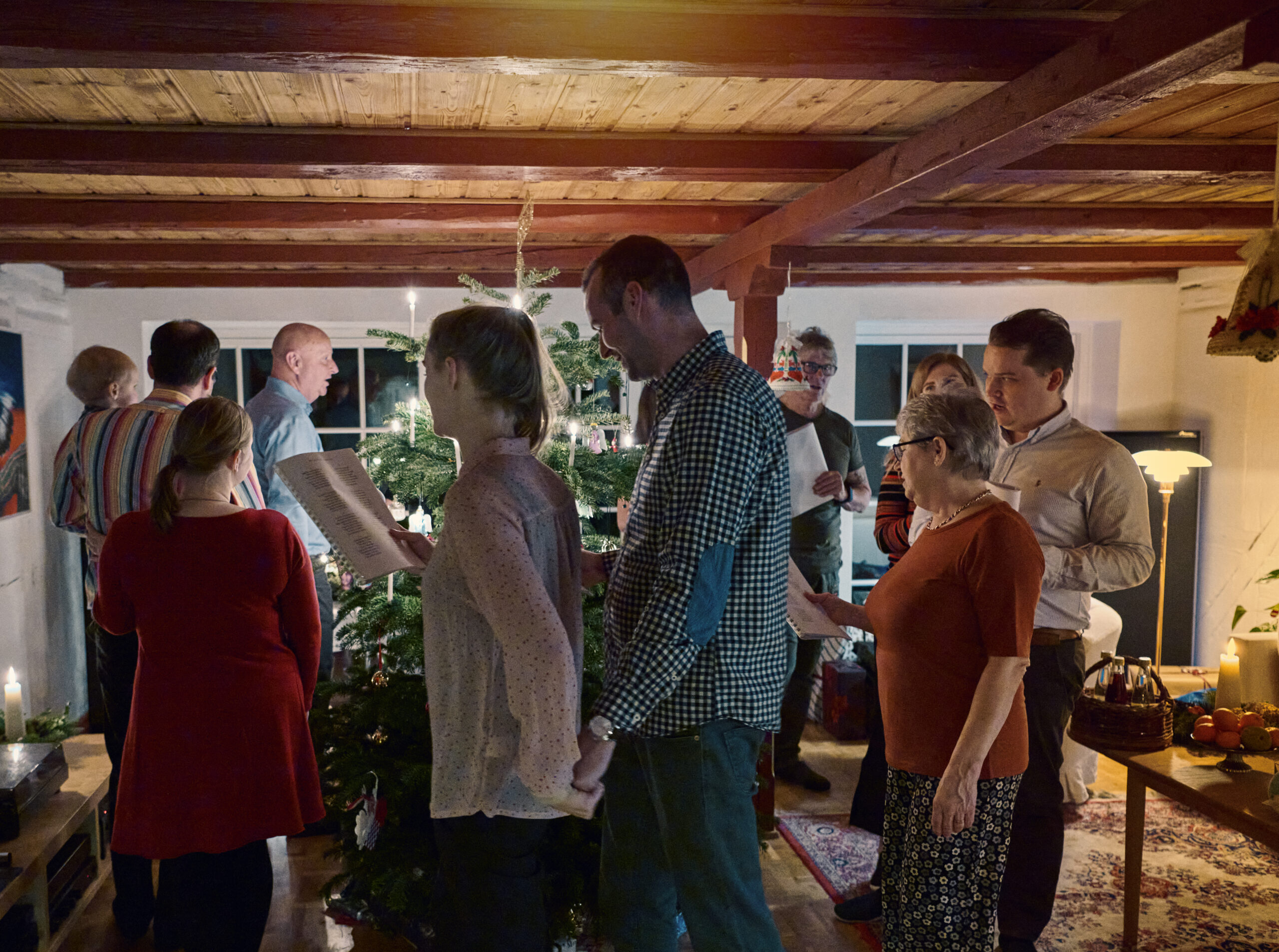 Family gathered around the Christmas tree Big family Christmas in old Danish house. Dance around the Christmas tree